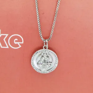 Close-up of a silver Virgin Mary pendant necklace featuring shell inlay and zircons