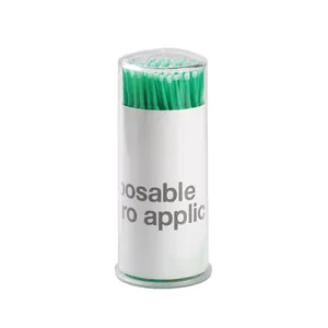 Disposable green micro applicators in a clear storage cylinder for eyelash extensions