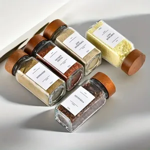 Detailed view of 4oz glass spice jars featuring elegant acacia wood lids and labels