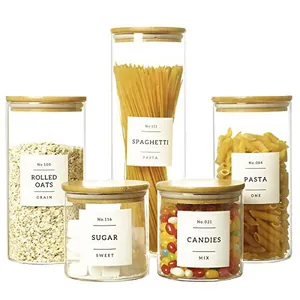 Five-piece transparent glass storage jar set with airtight bamboo lids for kitchen pantry.