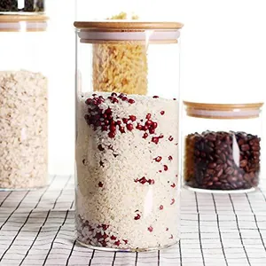 Close-up macro of airtight glass storage jars with bamboo lids filled with rice and beans