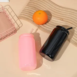 A set of 16oz soda can shaped glass cups in pink and black with lids and straws.