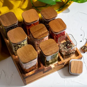Detailansicht quadratischer Gewürzgläser mit Akazienholzdeckeln in einem Holz-Organizer.
