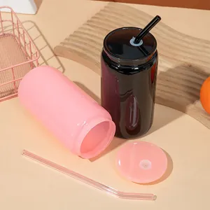Detail view of 16oz pink and black can-shaped glass cups with matching lids and straws.