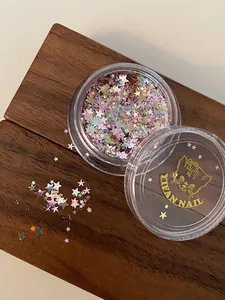 Primo piano di paillettes glitterate colorate a forma di stella per nail art in barattolo