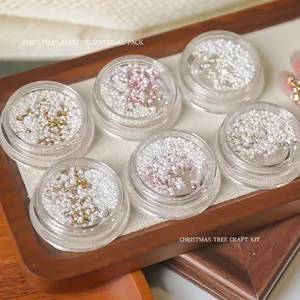 Christmas nail art material kit with zircon stars and pearls in clear containers.