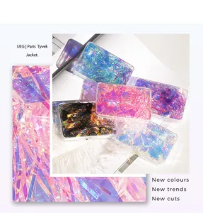 Close-up of iridescent aurora nail art cellophane flakes in five vibrant colors