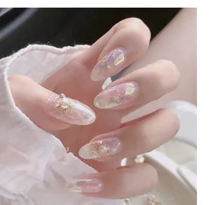 Macro view of iridescent aurora nail art stickers with star and pearl charms