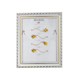 Elegant white and gold magnetic eyelash display frame with four-leaf clover applicators