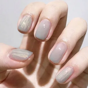 Close-up of manicure using iridescent aurora cellophane fragments with laser laser effects