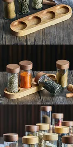 Close-up detail of glass spice jars with natural acacia wood and bamboo lids
