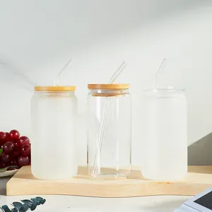 Detailed view of 16oz frosted and clear glass can cups with bamboo lids and glass straws