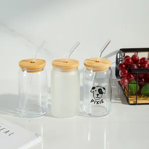 Set of three 16oz glass can cups with bamboo lids and straws in lifestyle setting