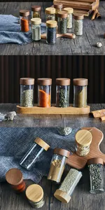 Macro detail view of 3oz round glass spice jars with acacia wood lids and matching base