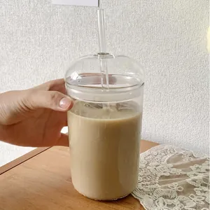 Close-up of 500ml high borosilicate glass cup with dome lid and reusable glass straw.