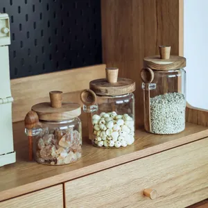 Detail view of acacia wood lid glass jars with matching wooden spoons on a shelf