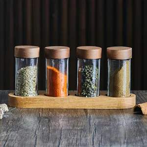 4-piece set of Japanese round glass spice jars with acacia wood lids and base