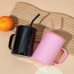 Close-up detail of two 17oz borosilicate glass mugs in glossy black and pink with straws