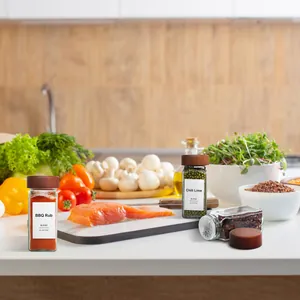 Close-up of 4oz glass spice jars with acacia wood lids in a kitchen setting