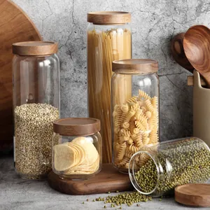 Set of glass food storage jars with natural acacia wood lids for kitchen organization