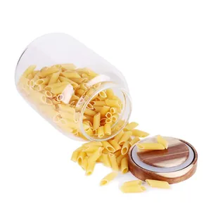 Detail view of high borosilicate glass storage jar with acacia wood lid and spilled pasta