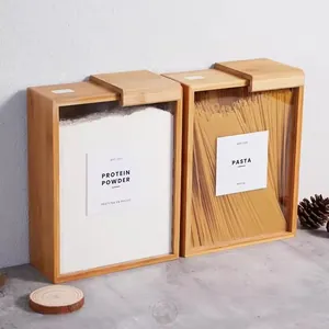 Detail view of bamboo food storage containers with sliding lids for pasta and powder.