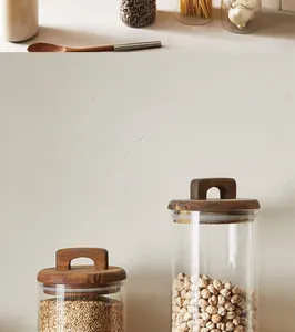 Detail view of Japanese-style acacia wood glass storage jars for kitchen grain organization