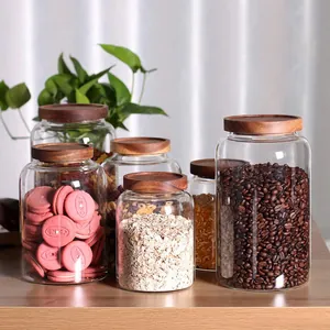 Transparent glass storage jars with airtight acacia wood lids for coffee and grains