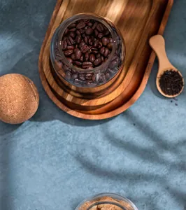 Detailed top view of a borosilicate glass jar filled with coffee beans and a round cork lid