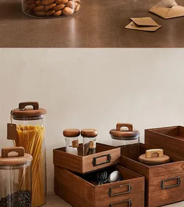 Detail view of Japanese acacia wood lid glass storage jars and wooden crates for kitchen