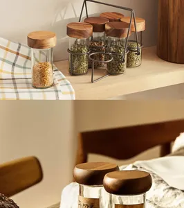 Close-up view of acacia wood spice jars on a wooden shelf with metal organizer rack.