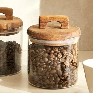 Airtight glass food storage jar featuring an acacia wood handle lid for coffee beans
