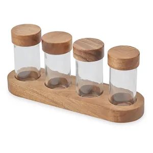 Elegant set of four 90ml glass spice jars with acacia wood lids and matching wooden base