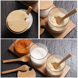 Set of 3 clear glass seasoning jars featuring natural bamboo lids, spoons, and a base tray
