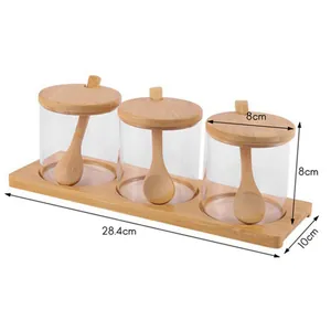 3-piece clear glass seasoning jar set with bamboo lids, spoons, and wooden base stand.