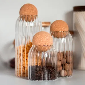 Set of three ribbed glass storage jars with spherical cork lids for coffee and nuts