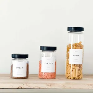 Three glass food storage jars with black pine wood lids for kitchen organization