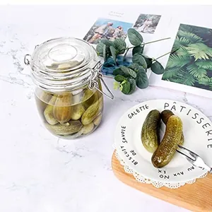 Oval glass storage jar with metal clamp lid for airtight food storage and pickling