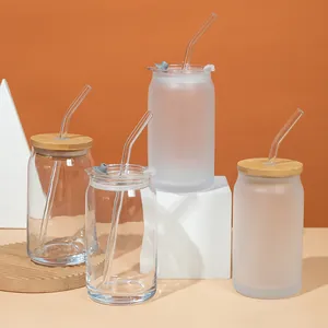 Detailed view of clear and frosted can-shaped glass cups with bamboo and plastic lids