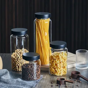 Set of various glass storage jars with black pine lids for kitchen organization
