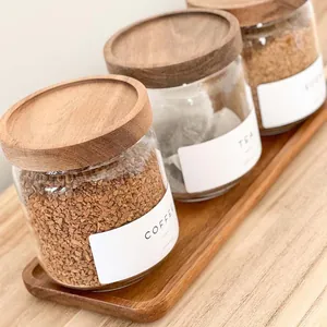 Detail shot of acacia wood lid glass storage jar set with coffee and tea labels