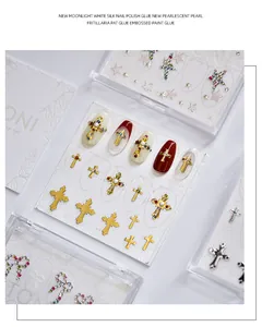 Detailed macro view of 3D embossed nail art stickers with gold cross and pearl charms
