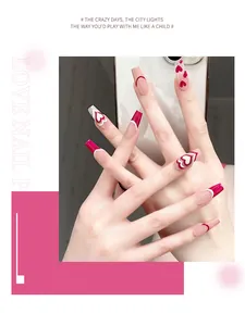 Detailed view of long coffin press-on nails with red heart patterns and french tips