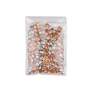 Premium champagne 5A cubic zirconia nail art charms stored in a clear mini bag for manicure