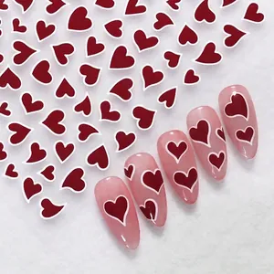 Red heart nail stickers with white border and demo application on peach nails