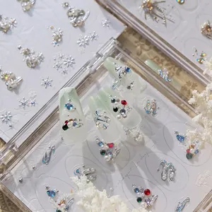 Christmas 3D embossed nail art stickers with pearl and snowflake designs on nails.