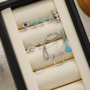 Close-up detail of titanium steel earring set featuring turquoise and white zircons