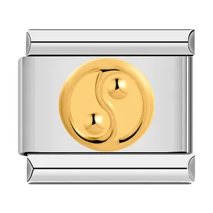 Detailed macro view of stainless steel Italian charm with golden relief Yin Yang symbol