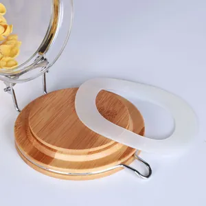 Detailed macro view of borosilicate glass storage jar with bamboo lid and silicone ring