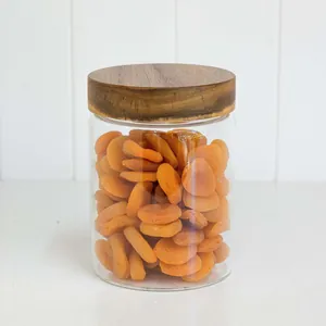 Tarro de cristal transparente con tapa de madera de acacia y albaricoques secos